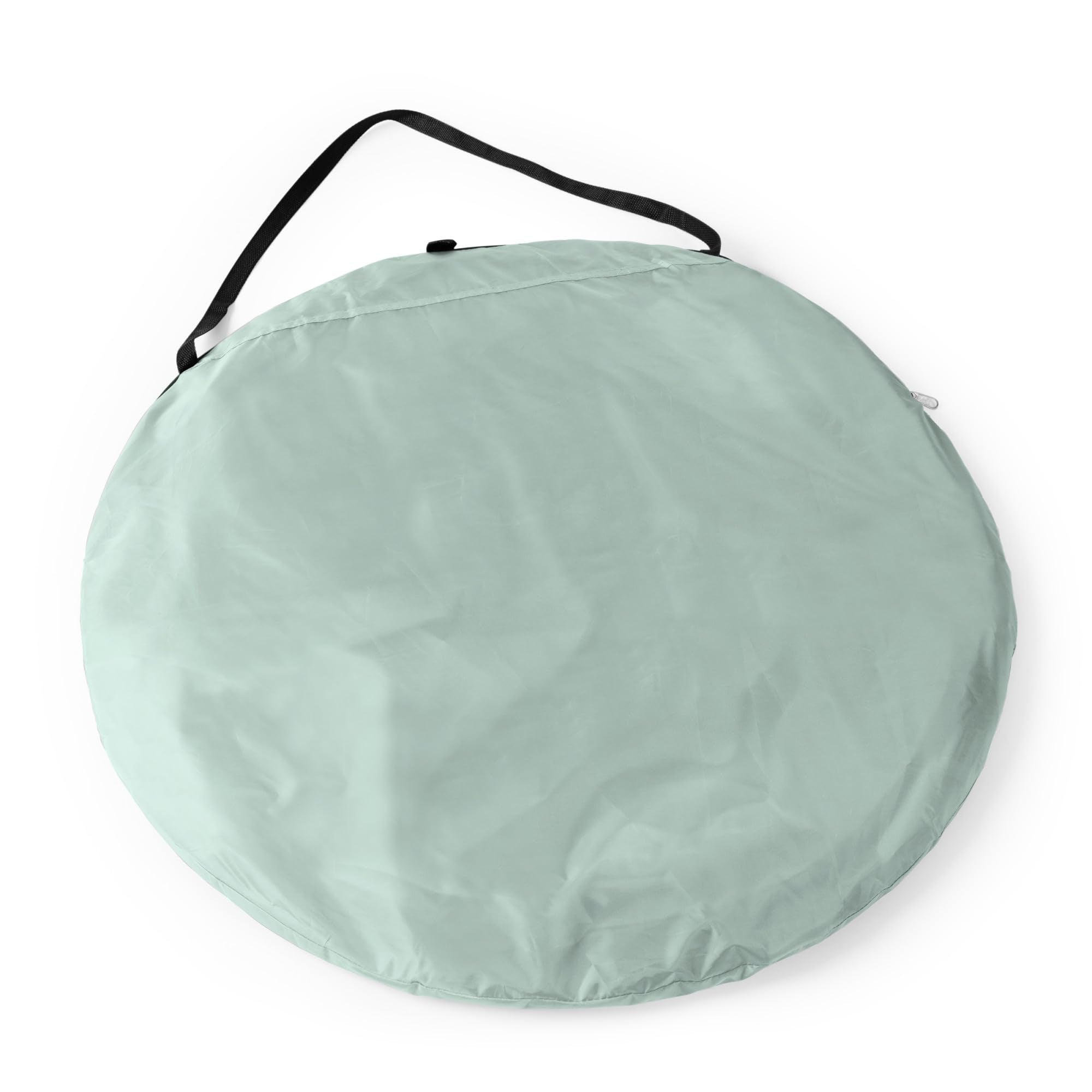 Sandbags and ground stakes secure the tent on sand.