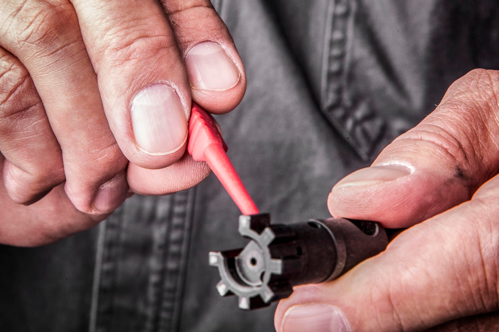 Pistol and rifle cleaning kit components with angled bronze brush