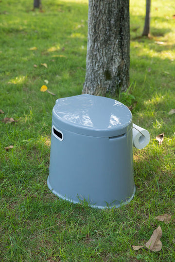 Playberg portable toilet features integrated paper holder for quick access.
