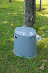 Playberg portable toilet features integrated paper holder for quick access.