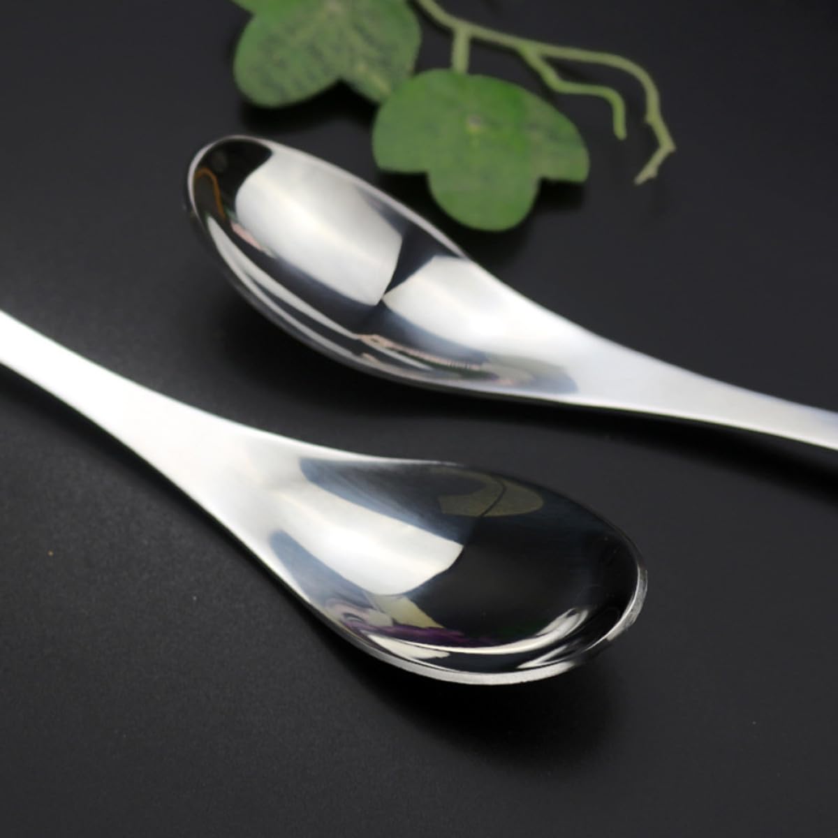 Close-up of PRETYZOOM spork and spoon in stainless steel finish, durable for outdoor meals.