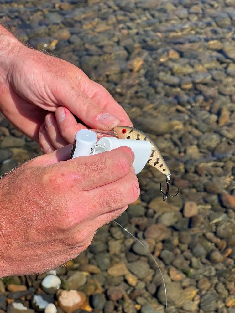 UV-enhanced Bait Waxx dispersing scent trail for lure attraction.