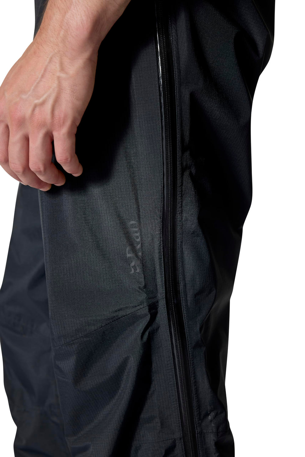 Rab Downpour Mountain Pants on a damp trail scene convey reliable waterproof performance