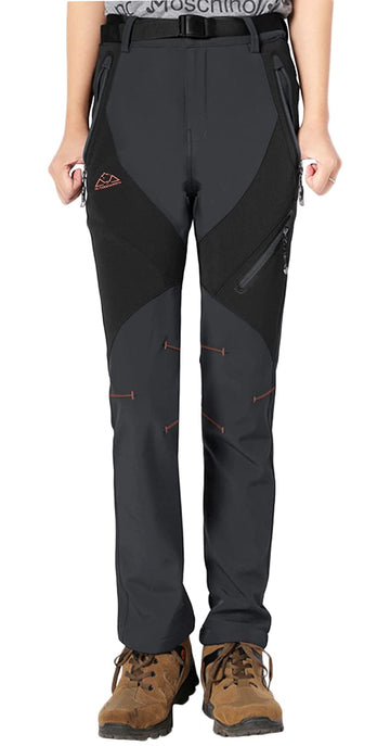 Rdruko women's winter hiking pants windproof outer layer shields against gusts on mountain passes.