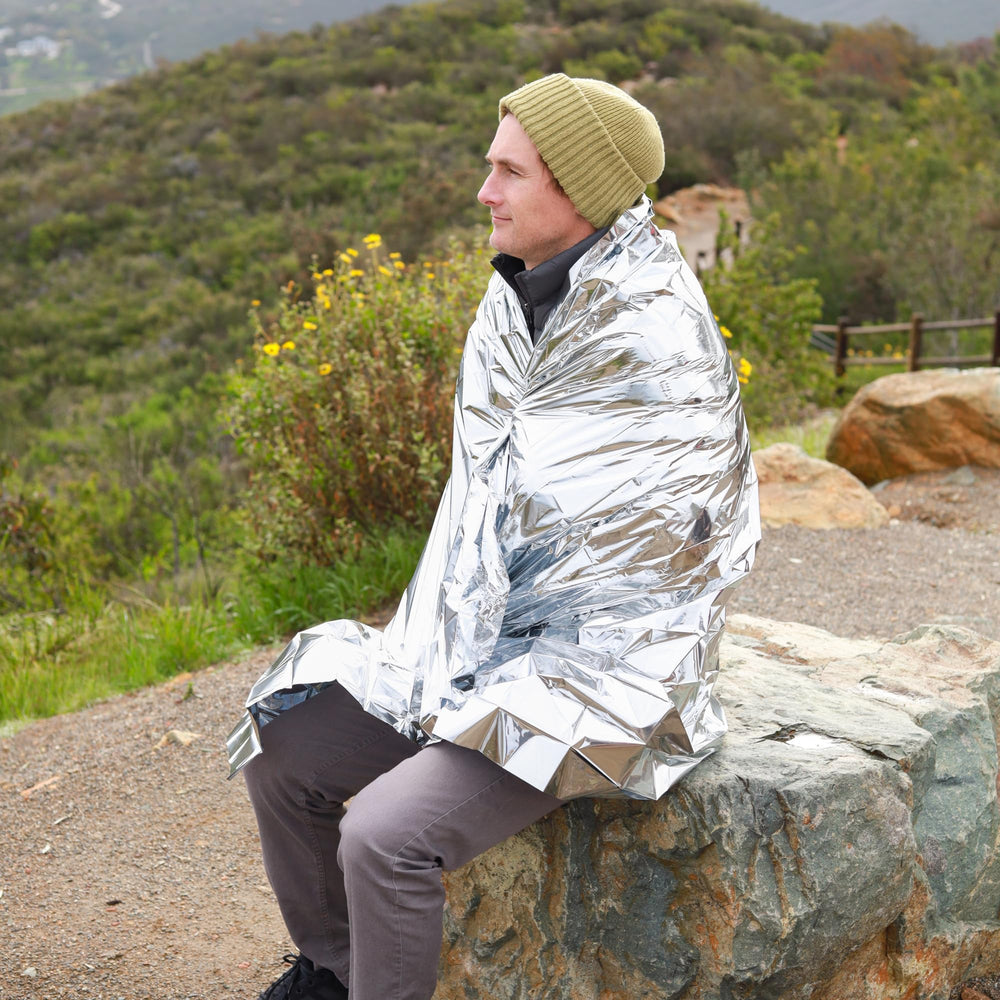 Ready America emergency blankets used as poncho or shelter in outdoor scenarios.