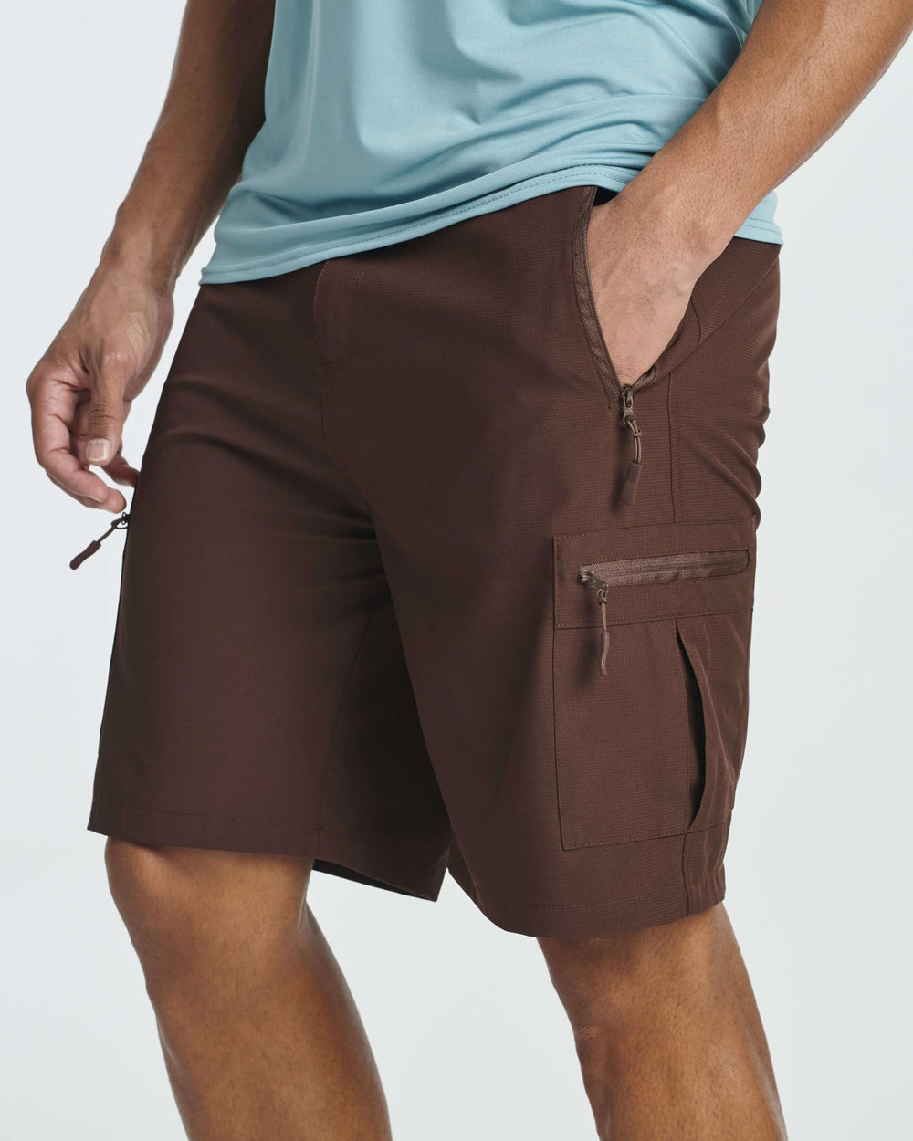 Real Essentials shorts in action on a rugged trail for versatile outdoor use