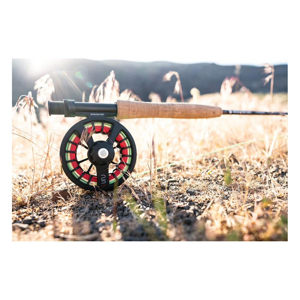 Redington Black 3-4 reel in-hand use illustrates ergonomic casting feel.