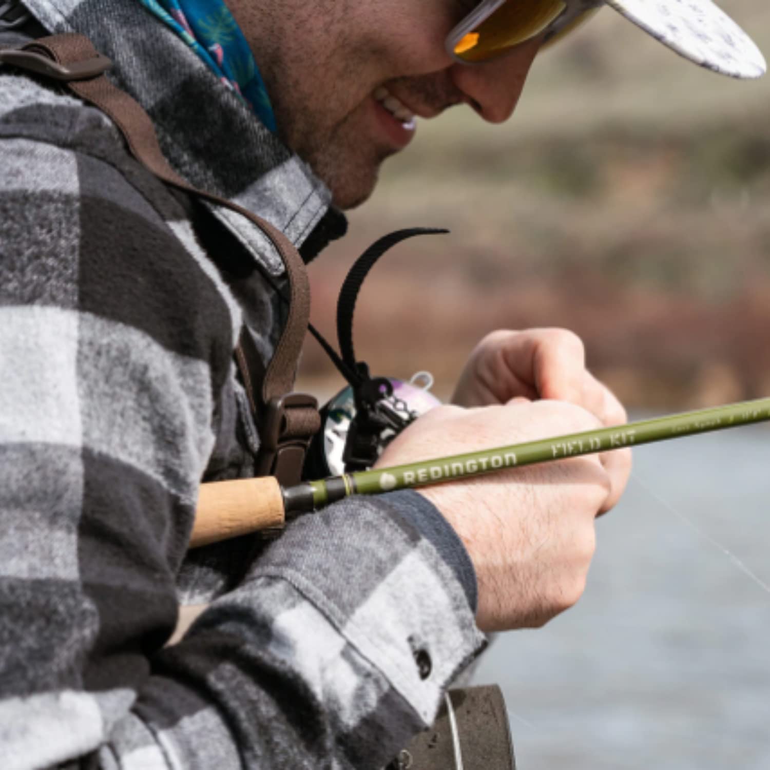 Redington field kit on riverbank evokes real-world trout fishing