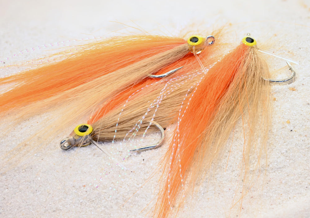 Region Fishing Cheat Code Saltwater Fly in orange and tan targets tarpon, snook, and redfish.