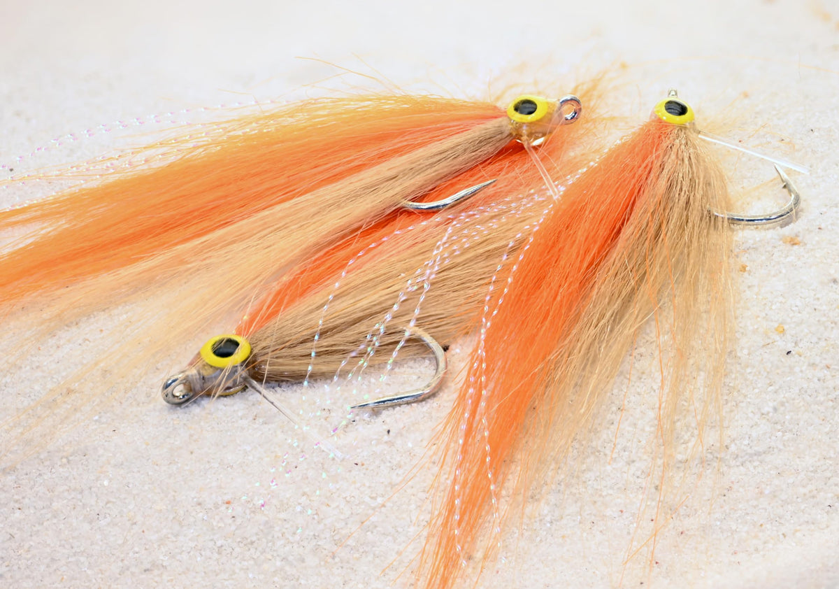 Region Fishing Cheat Code Saltwater Fly in orange and tan targets tarpon, snook, and redfish.