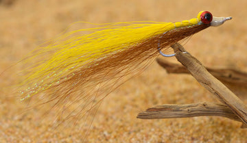Close-up of lead eyes on Clouser Minnow flies highlighting saltwater durability and realistic profile.