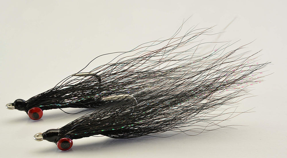 Hand-tied Clouser Minnow flies by Region Fishing ready to tempt a variety of species.