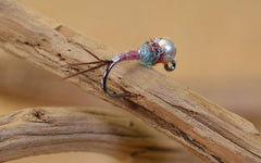 Region Fishing Rainbow Warrior jig fly in water with vivid colors for enticing presentations.