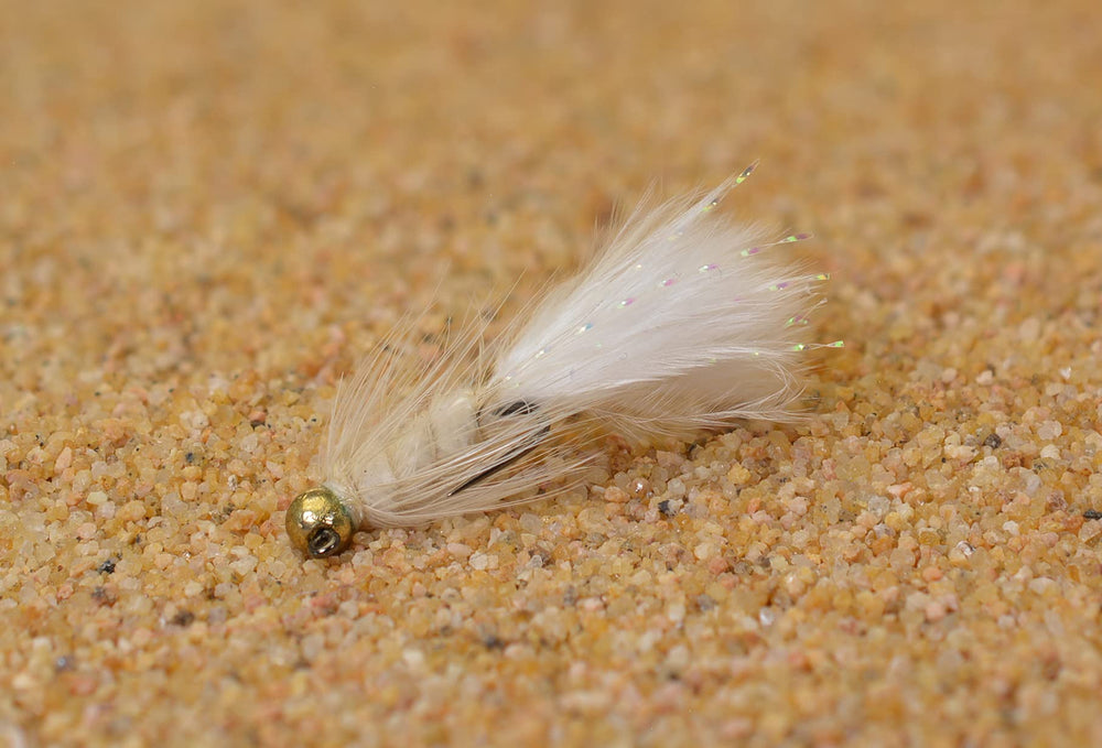 Region Fishing white Woolly Bugger close-up for visibility in clear water