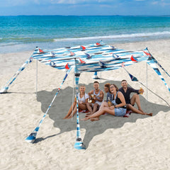 Rhino Valley Beach Tent 10x10 blue sailboat setup provides quick shade for family beach days.
