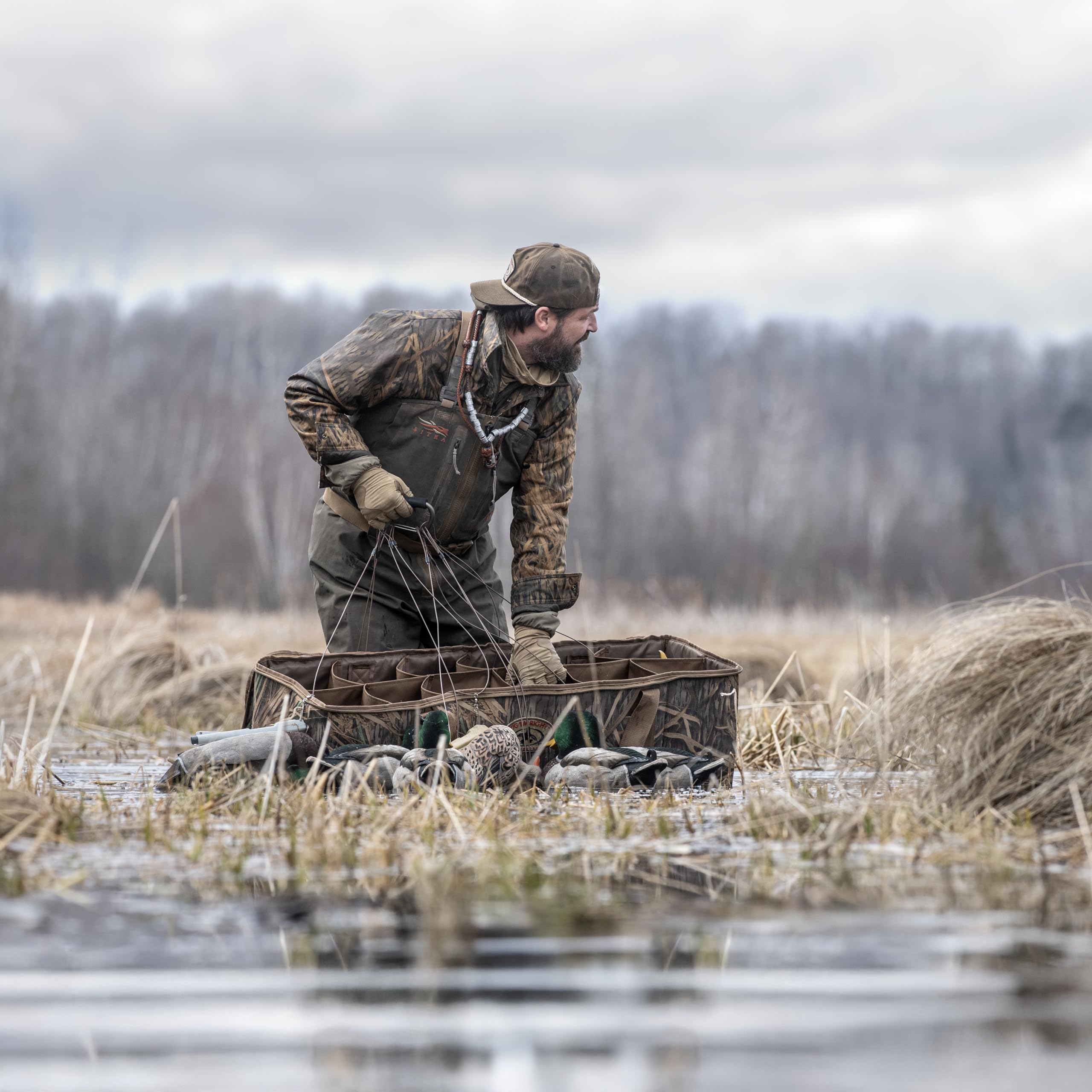 Rig Em Right Mossy Oak Shadowgrass camo bag blends into marshy surroundings.