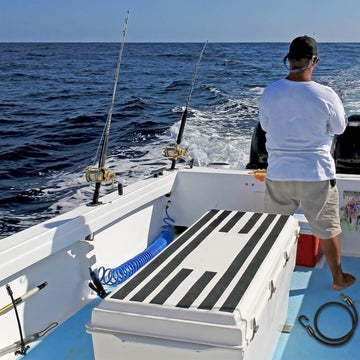 Deck mount rod strap shown in installation on boat or kayak