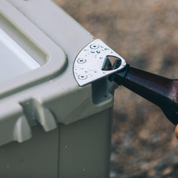 RTIC cooler lid includes silicone cargo net for small item organization.