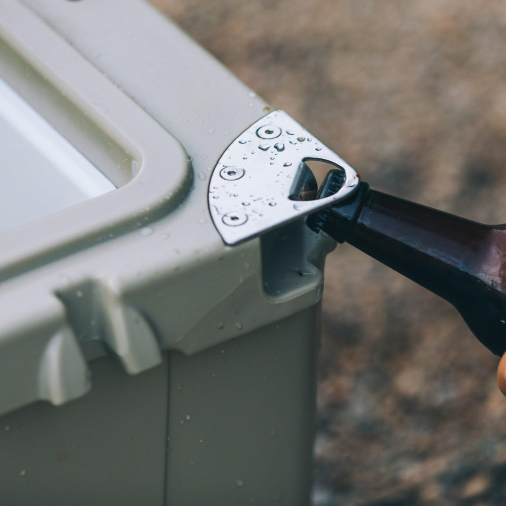 RTIC cooler lid includes silicone cargo net for small item organization.
