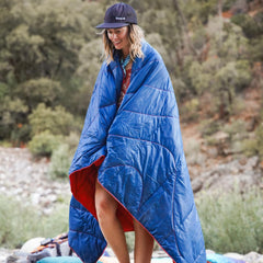 Rumpl blanket folded compact to show portable comfort for travel.