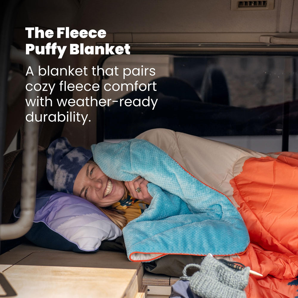 Rumpl fleece puffy blanket Deepwater rolled pack demonstrates compact portability.