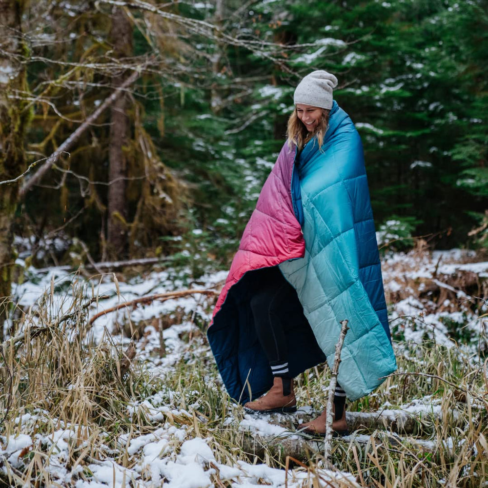 Rumpl Nanoloft Puffy Blanket Crisp Fade packed in its stuff sack for travel