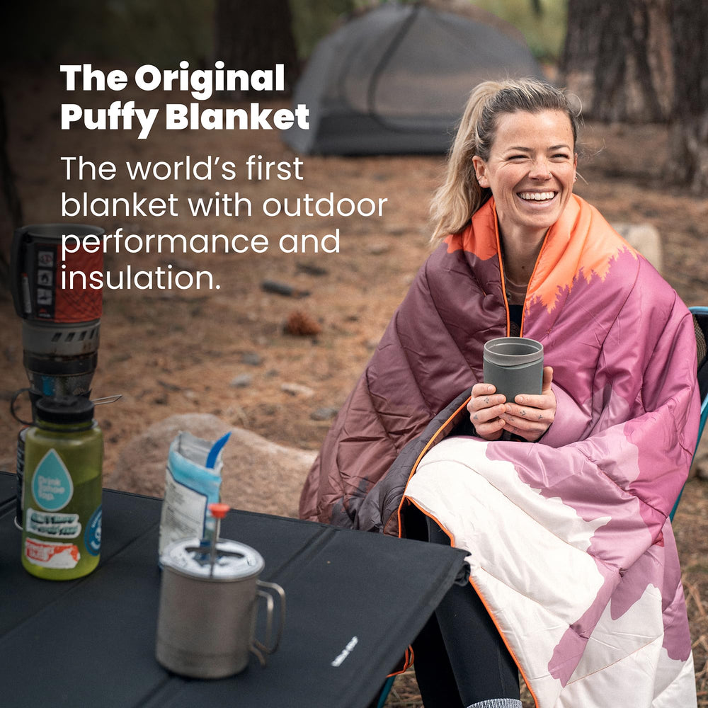 Rumpl Original Puffy Blanket rolled inside roll-top sack highlights compact storage