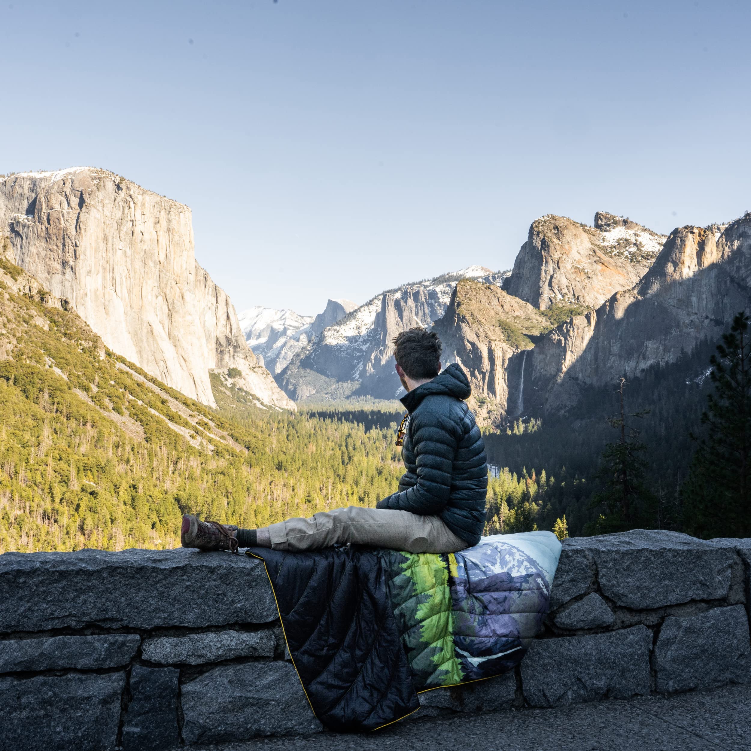 Rumpl Original Puffy Yosemite blanket in a campsite setup for chilly outdoor evenings.