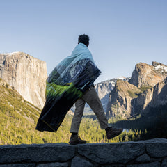 Rumpl Original Puffy Yosemite blanket unfolded ready for campsite warmth.