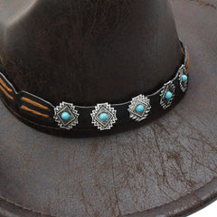 Close-up of faux leather texture and buckle belt on Sandy Ting hat