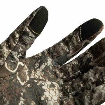 ScentBlocker Underguard gloves on hand using a touchscreen device in cold weather.