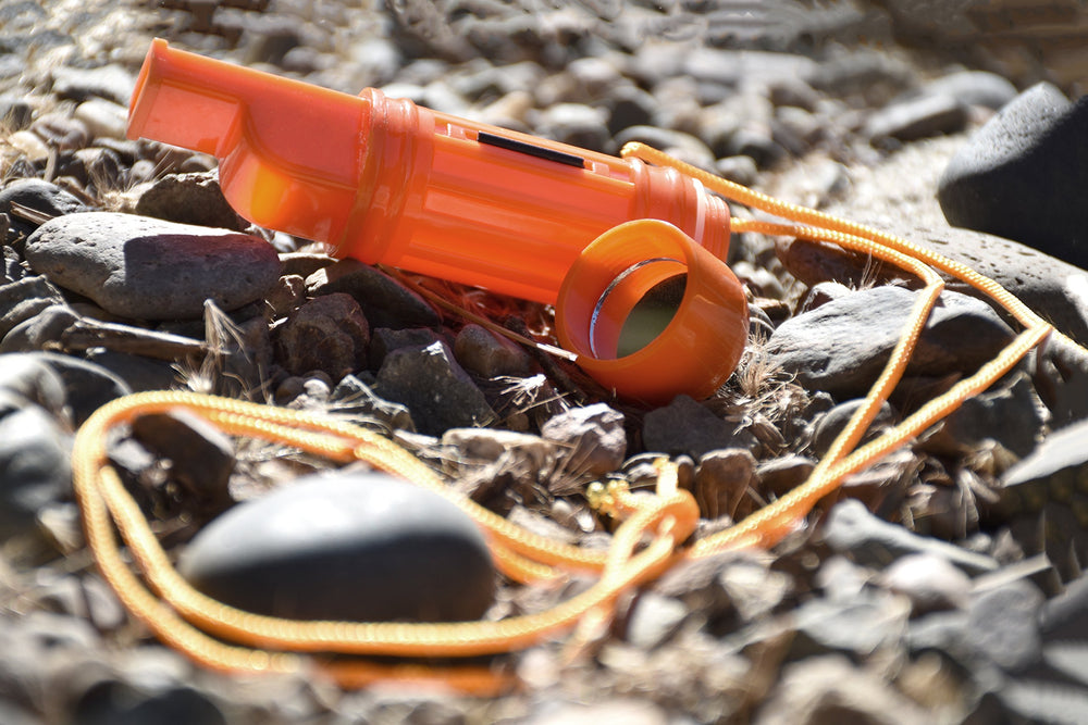 SE orange whistle on a durable lanyard keeps gear accessible.