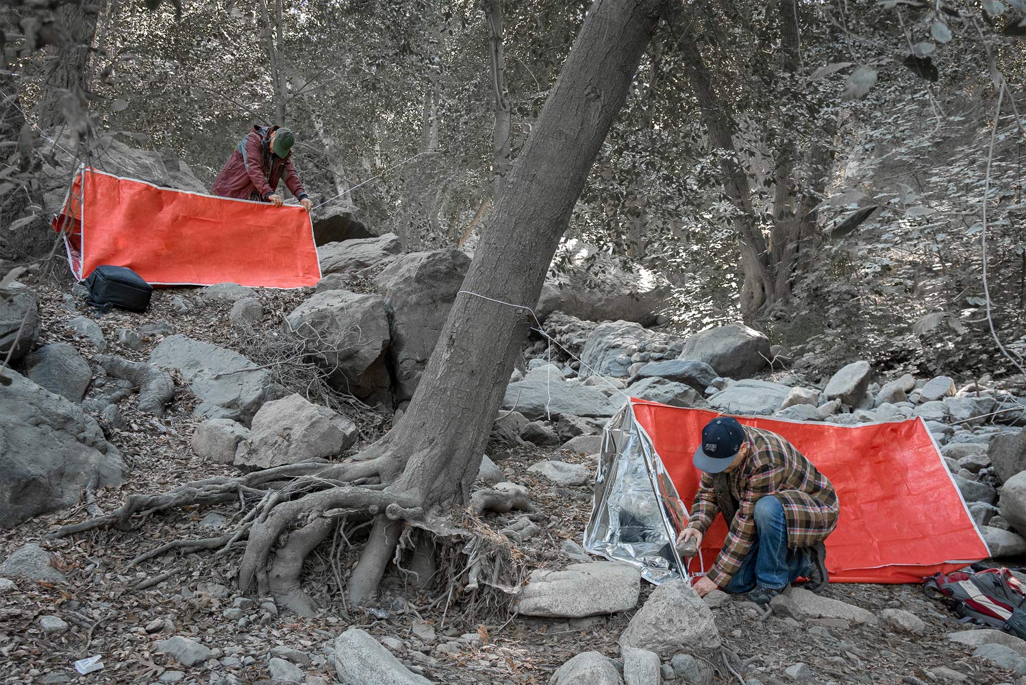 SE Emergency Tube Tent with steel pegs for quick shelter setup.
