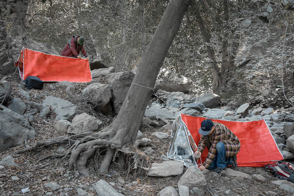 SE Emergency Tube Tent with steel pegs for quick shelter setup.