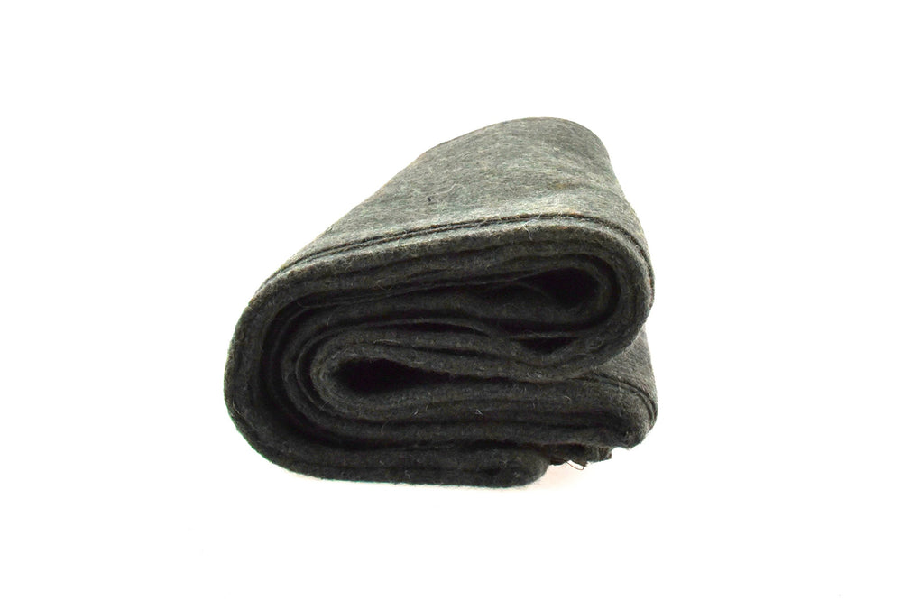 SE Green blanket in use during camping for warmth.