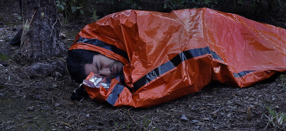 SE Survivor Series Emergency Sleeping Bag EB122OR serves as a rain shield outdoors.