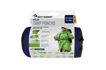 Sea to Summit poncho royal blue worn as raincoat for weather protection.