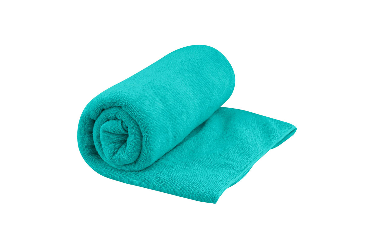 Sea to Summit Tek Towel folded in Baltic Blue shows plush handfeel for easy packing