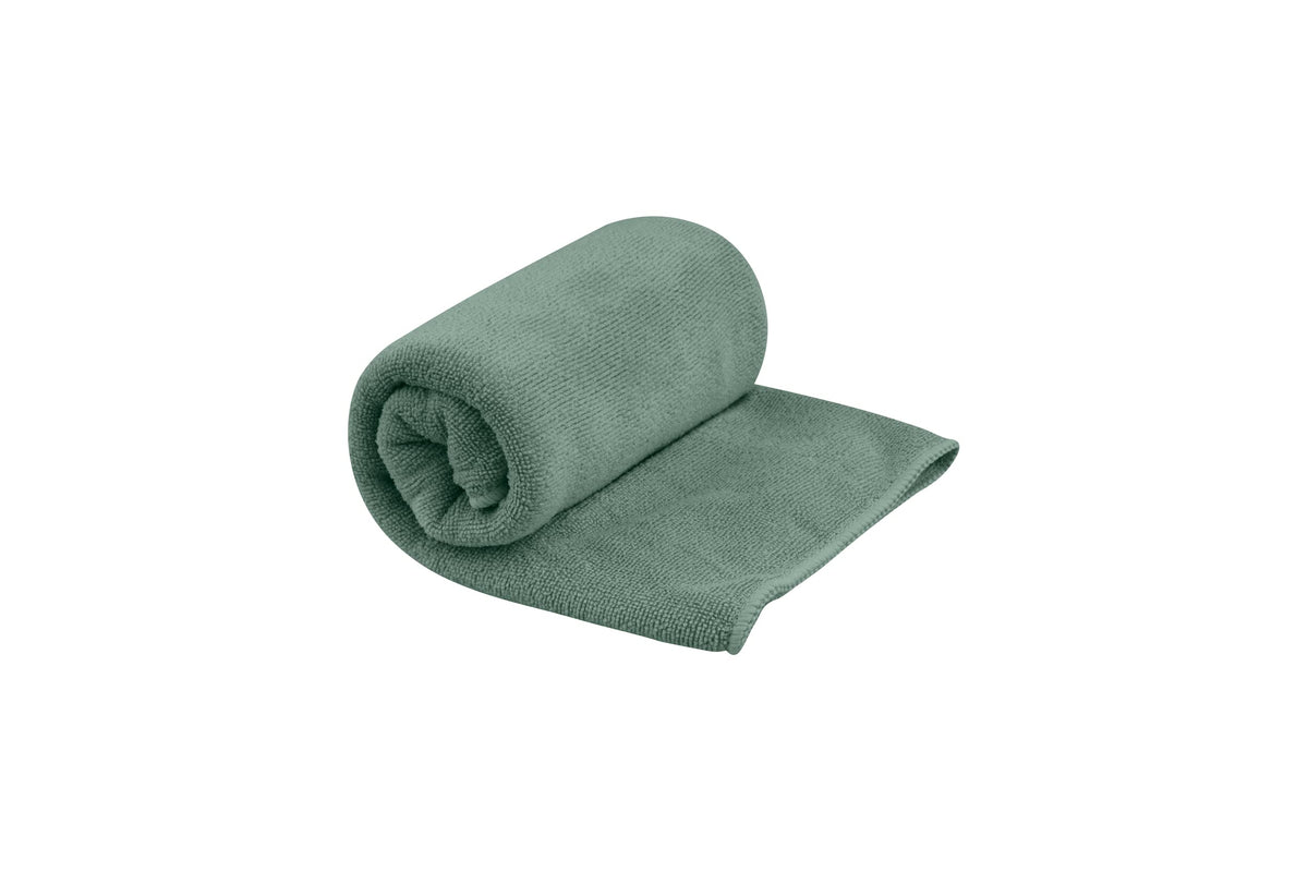 Sea to Summit Tek Towel Small Sage Green folded for easy packing and plush comfort.