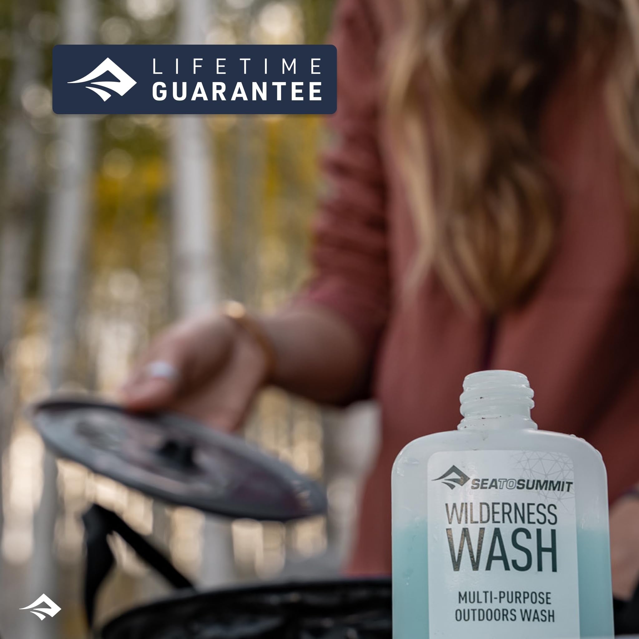 Sea to Summit Wilderness Wash travel-essentials image highlights TSA-friendly 100 ml bottles.