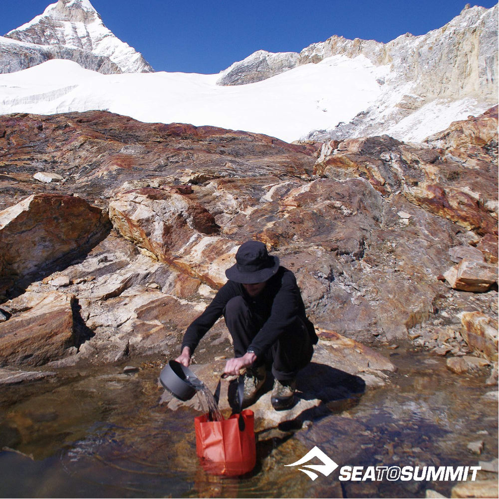 Sea to Summit folding bucket packed in pouch for compact travel.