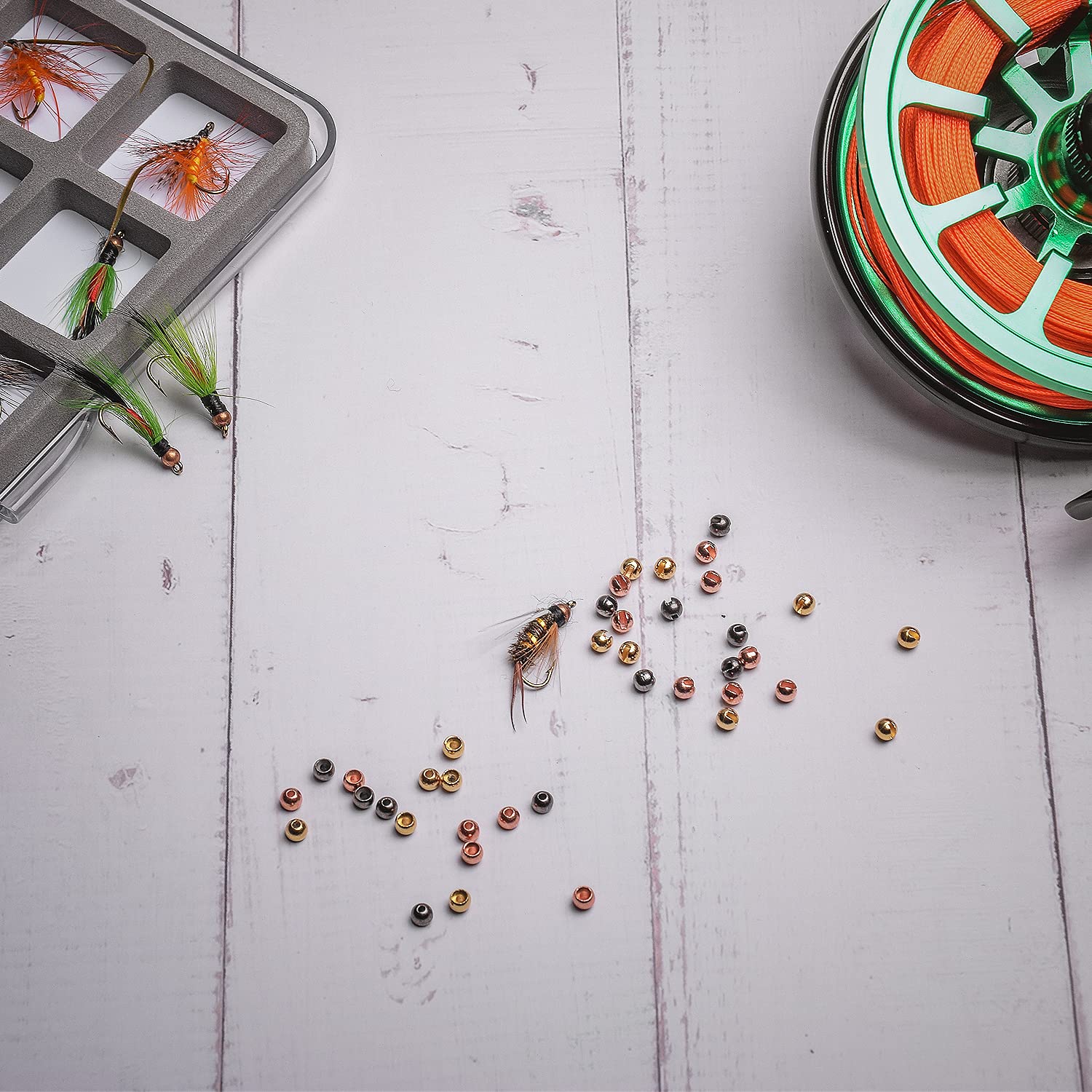 Fly tying with tungsten bead head eyes on a hook
