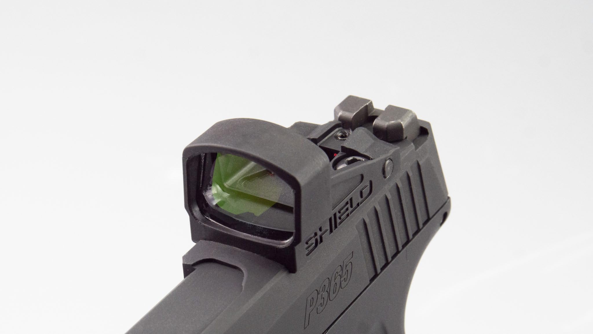 Shield Sights SMSc demonstrating co-witness with iron sights for versatile aiming.