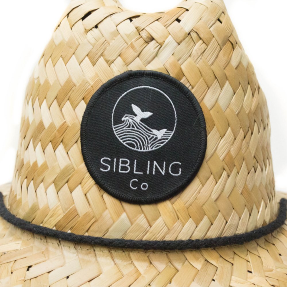 Sibling Co straw sun hat on a sandy beach for sunny days