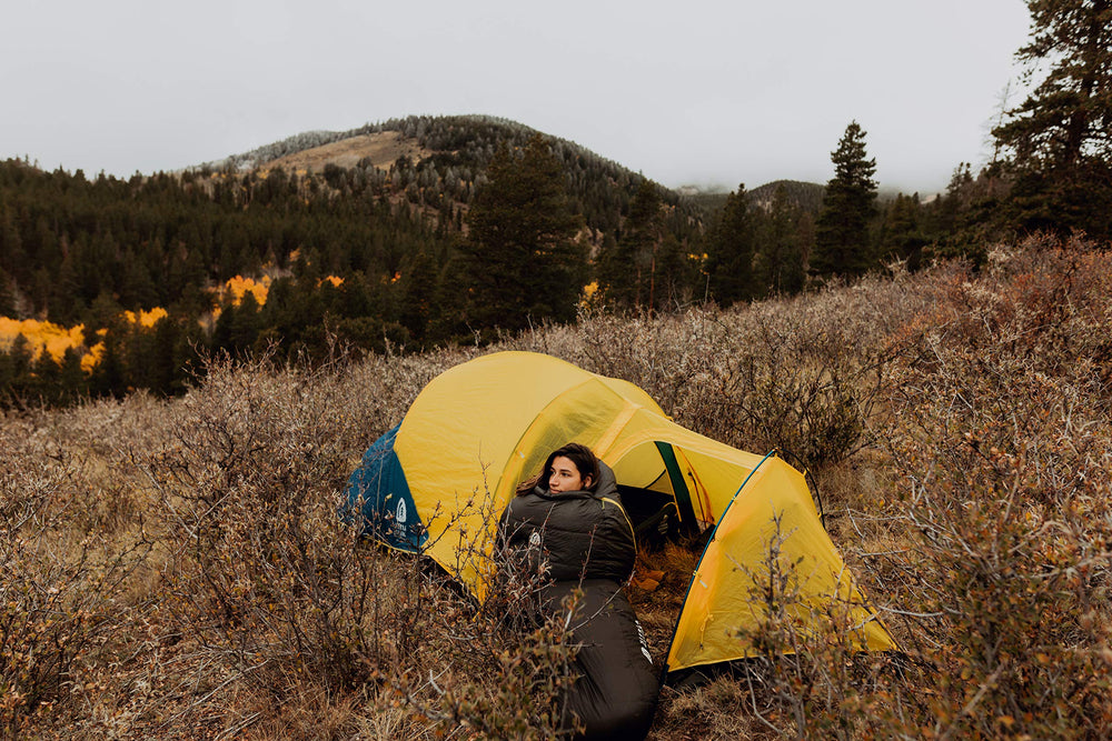 Sierra Designs Nitro sleeping bag beside backpack for scale and use