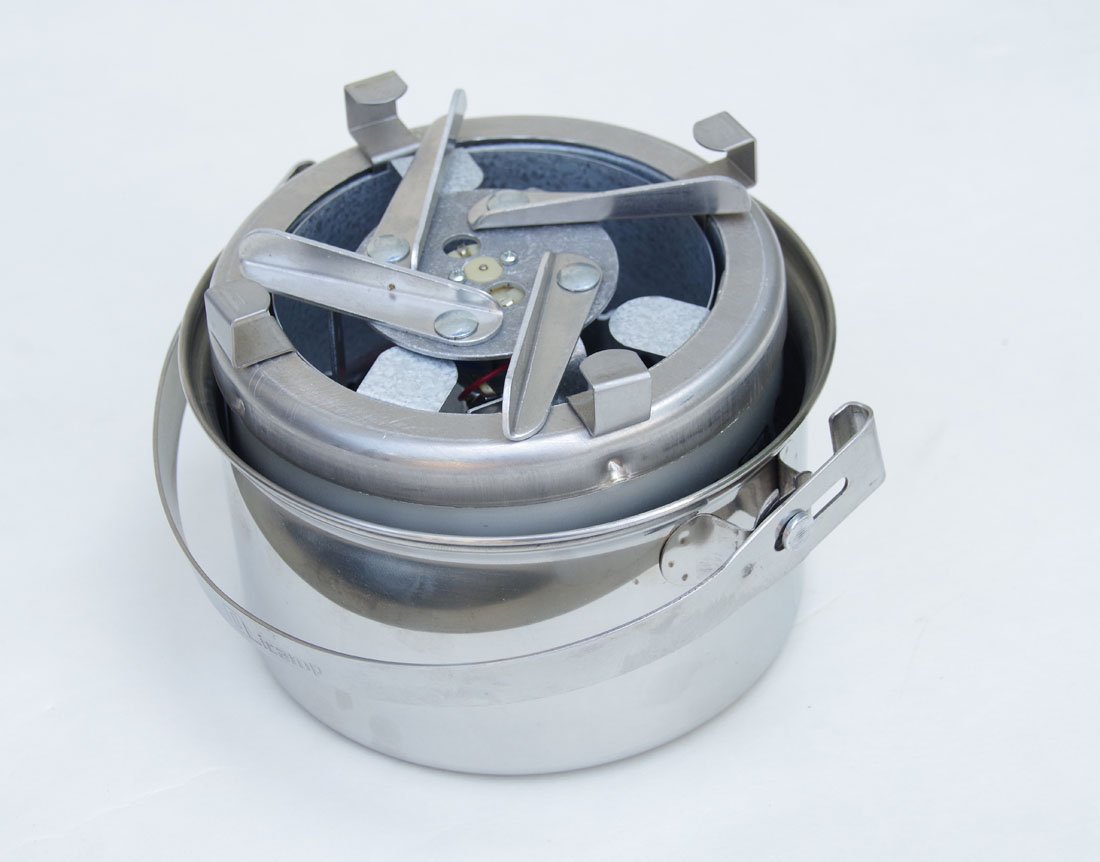 Sierra Stove in use over a campfire with wood fuels.