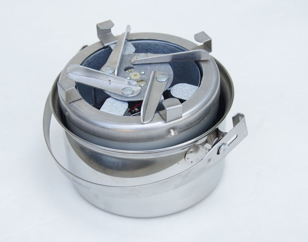 Sierra Stove in use over a campfire with wood fuels.