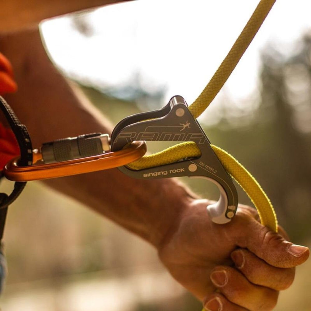 Singing Rock Rama orange side profile highlights slim, travel-friendly belay tool.