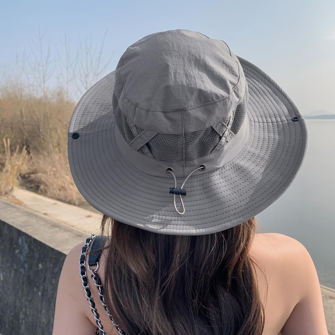 Grey Sireck fishing hat worn outdoors in a sunny setting