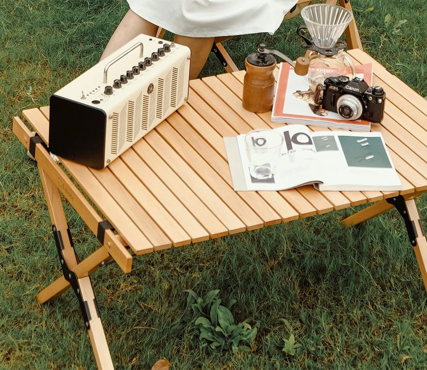 S'more folding picnic table open on campsite shows stable X-frame design.
